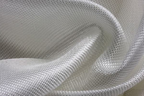 Close-up view of the material called fiberglass woven roving fabric, which is used in the industrial sector, made for houses, cars.